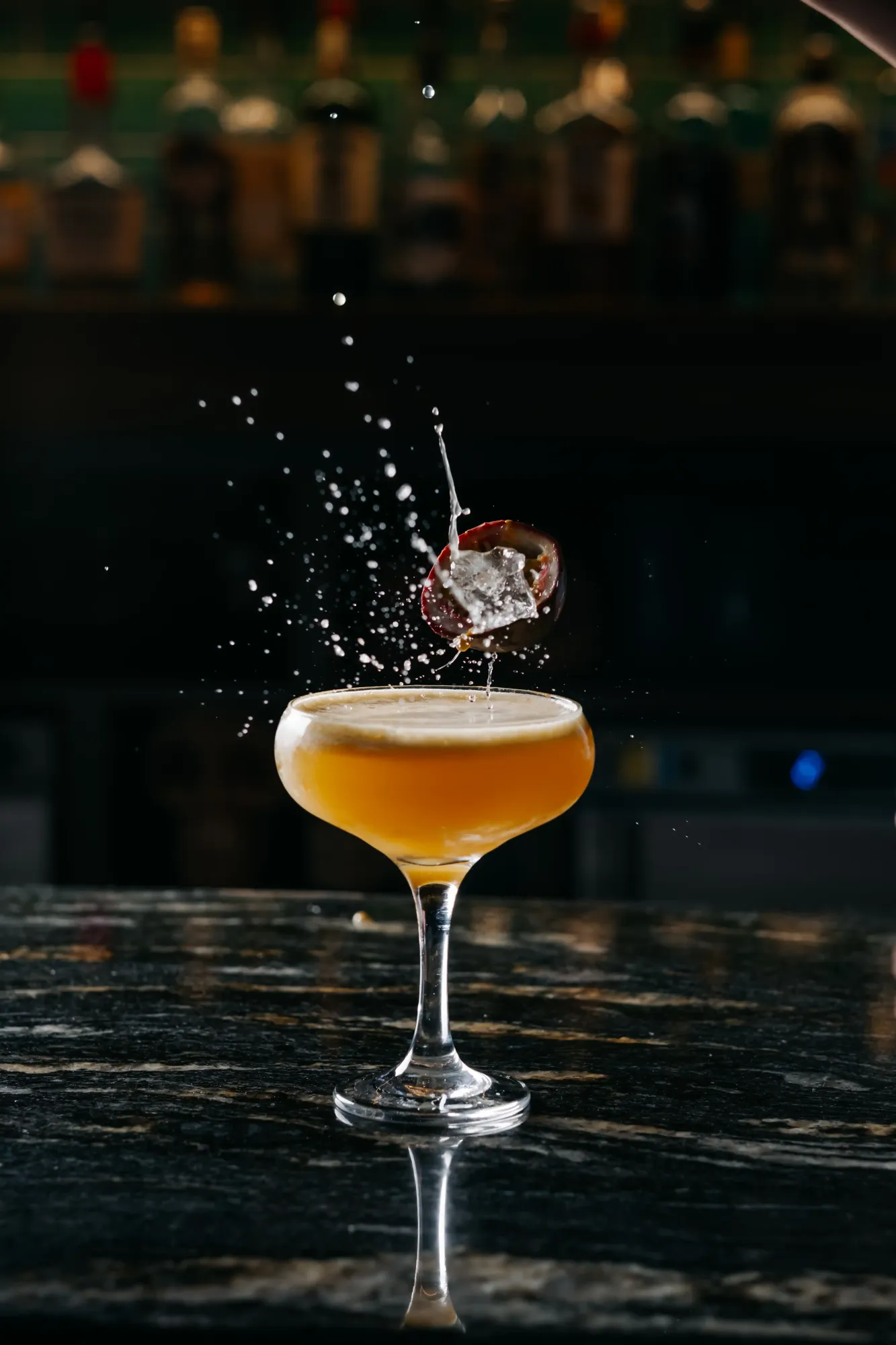 Passion fruit dropping into a Pornstar Martini at the Siamais bar